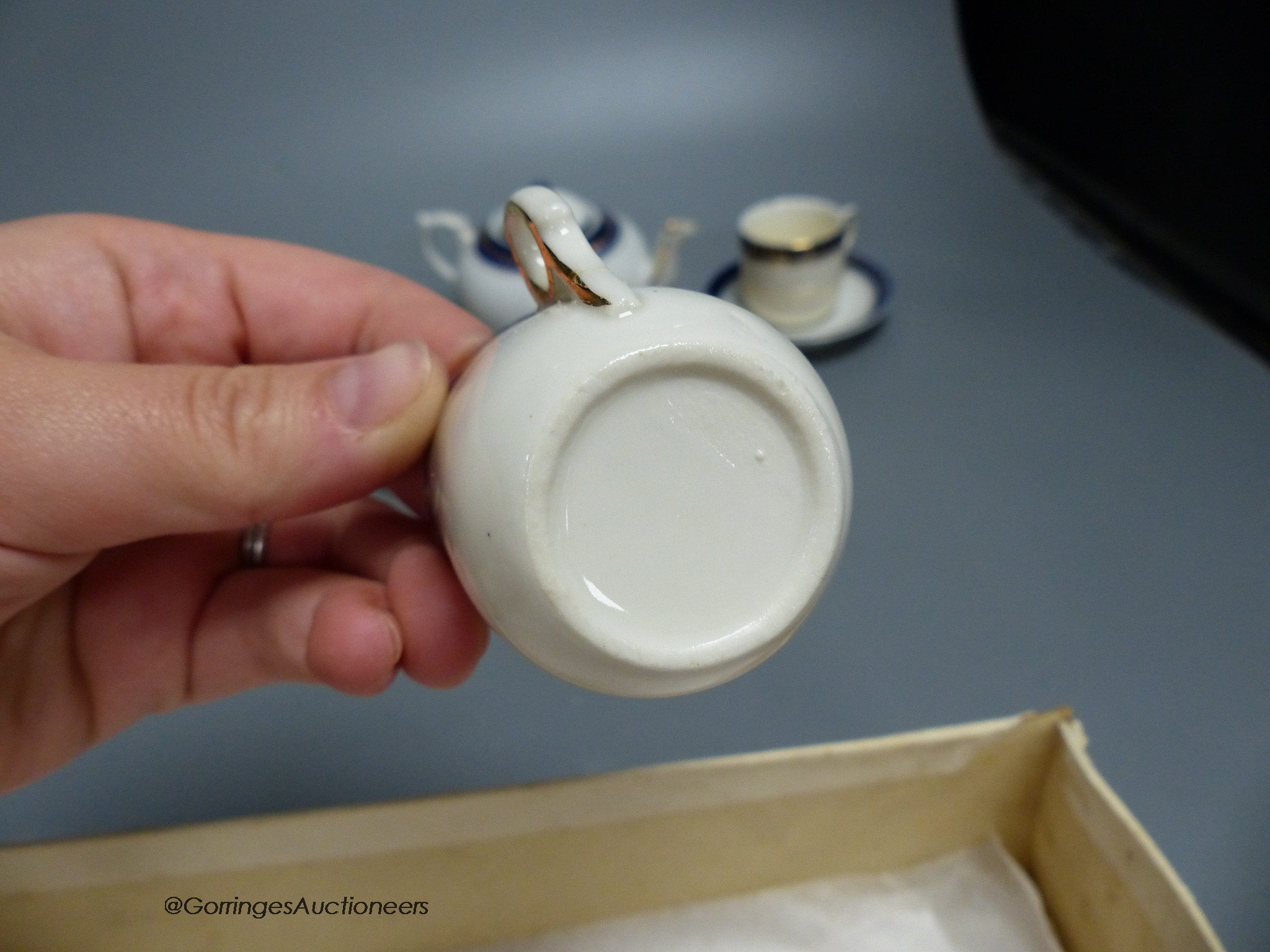 A child's tea set and a pair of leather shoes